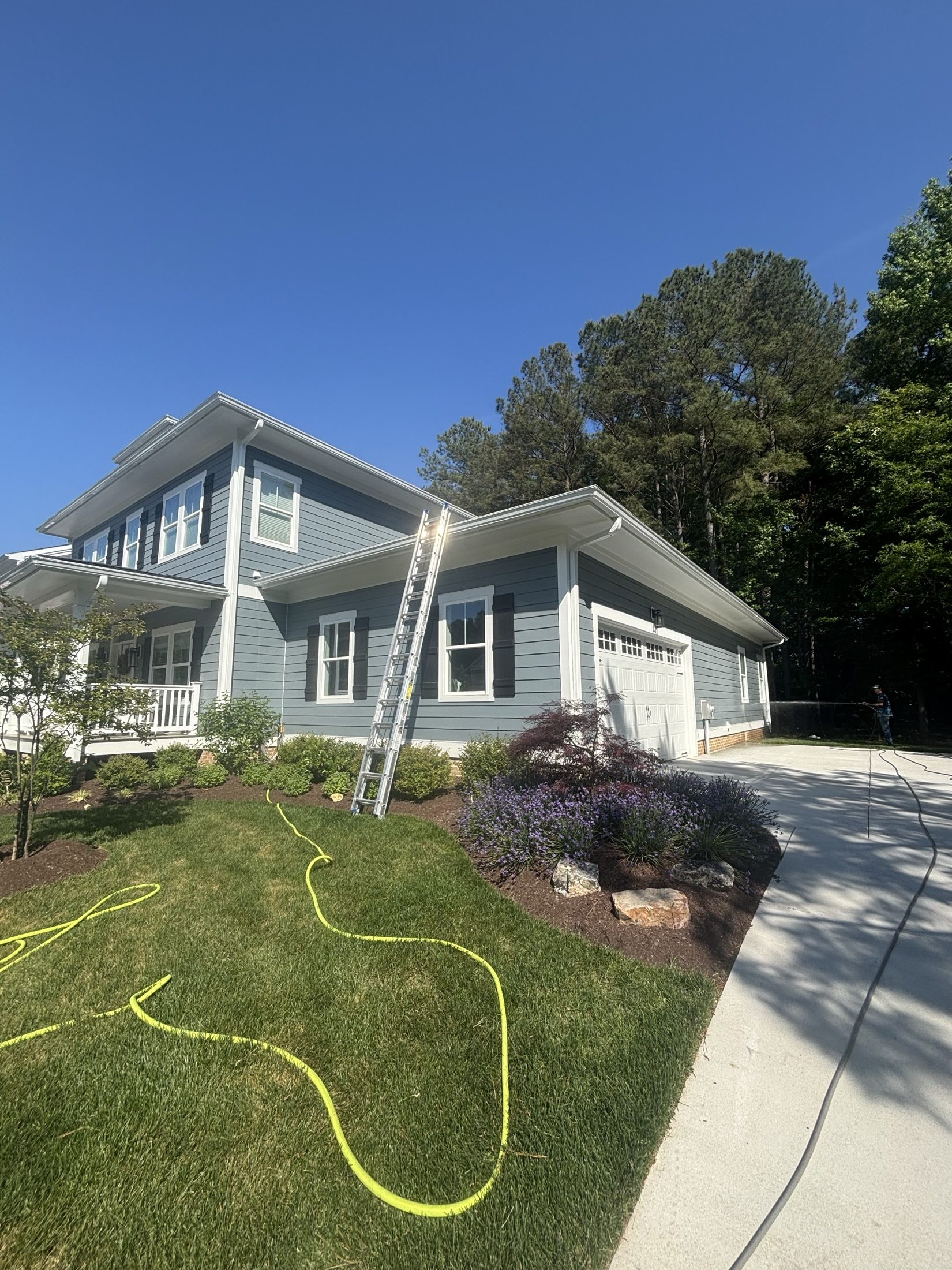 Gray coastal home with freshly soft washed siding and metal roof in Easton MD on Maryland's Eastern Shore