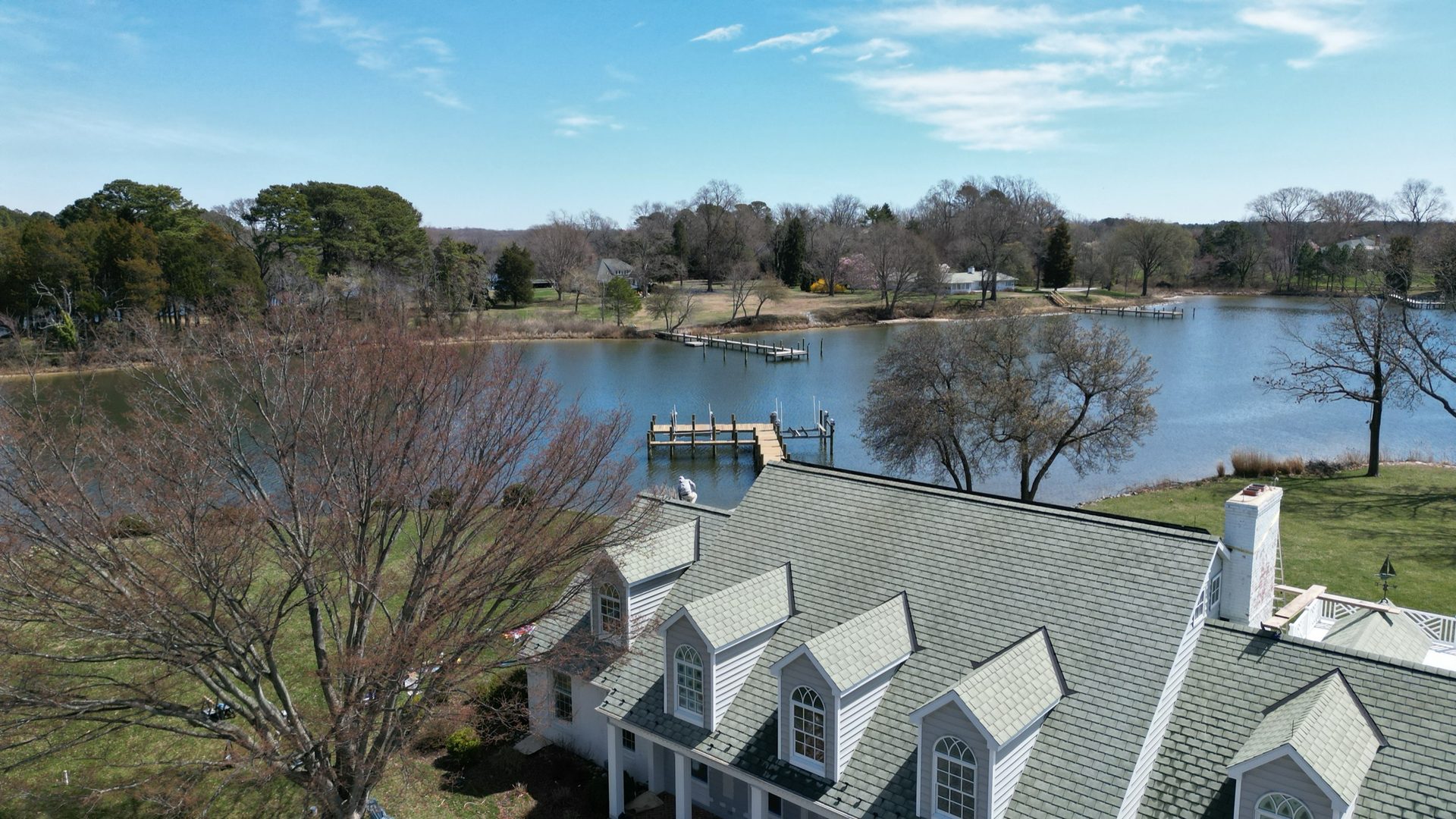 Aerial view of a soft-washed dormered shingle roof on a waterfront home in Easton MD on Maryland's Eastern Shore