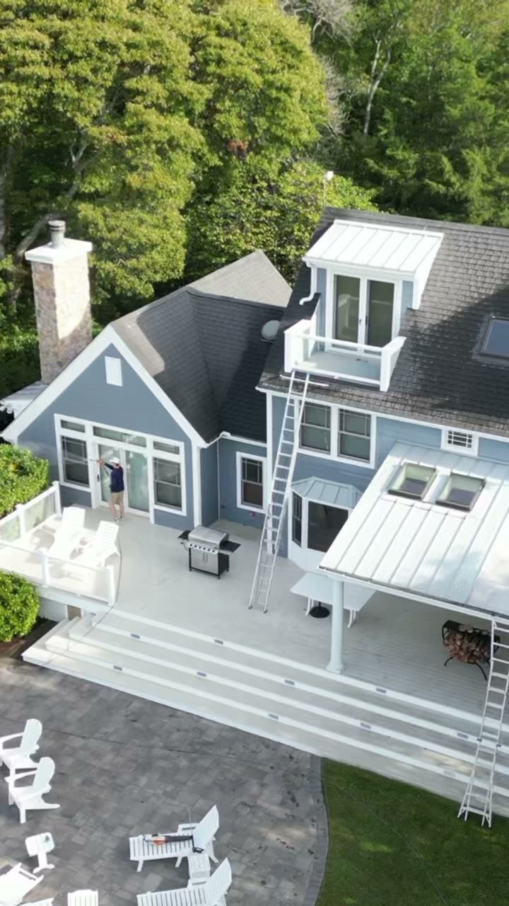 Drone view of a Coastal Shine technician soft washing a three-story coastal home on Maryland's Eastern Shore